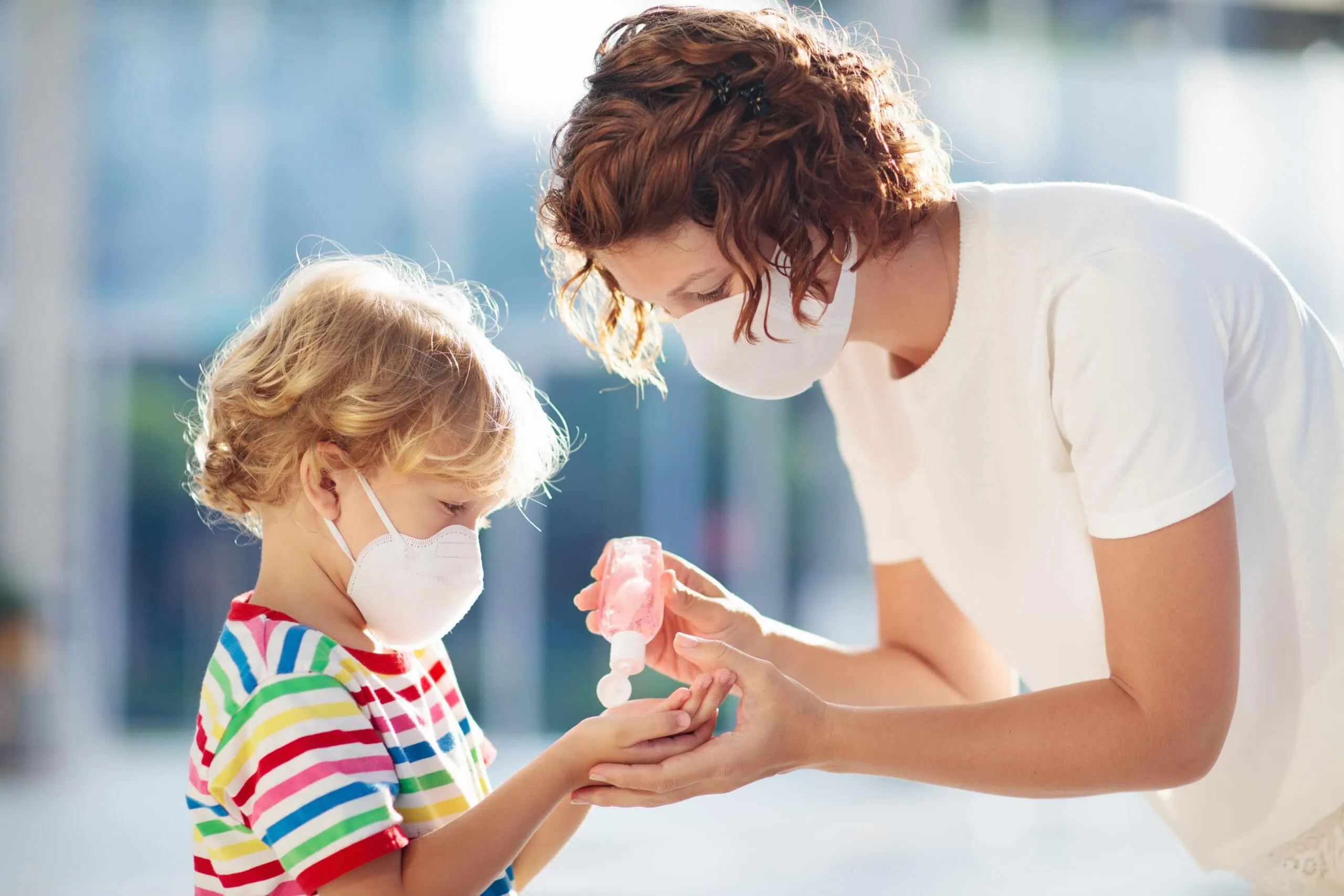 Mother And Child With Face Mask And Hand Sanitizer